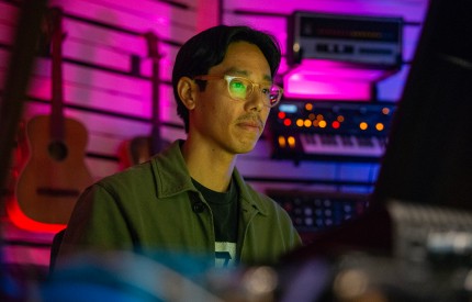 Person using a computer in a music studio